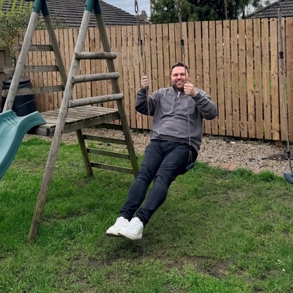 Michael on a swing in a Bradford back garden